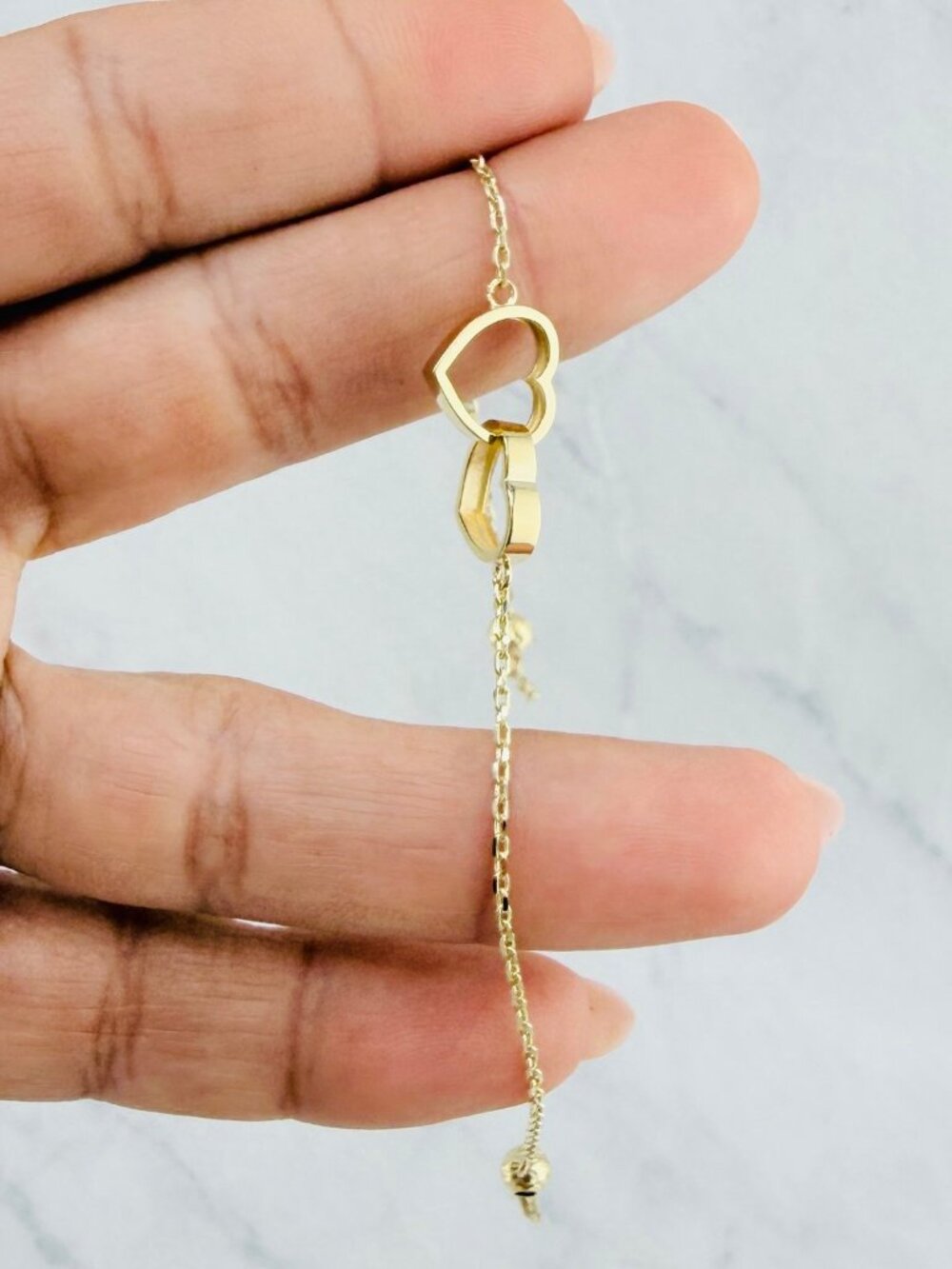 10K gold bracelet features two intertwined hearts 7" - Picture 4 of 6